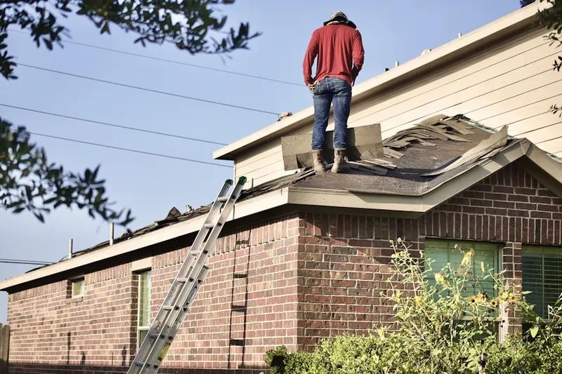 Professional roofer working on a residential roof in Tulip